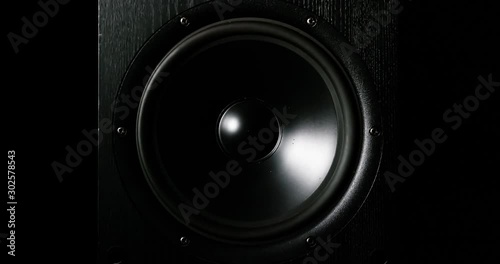 CLOSE UP moving sub-woofer music speakers vibrating membrane white strobe pulsing light