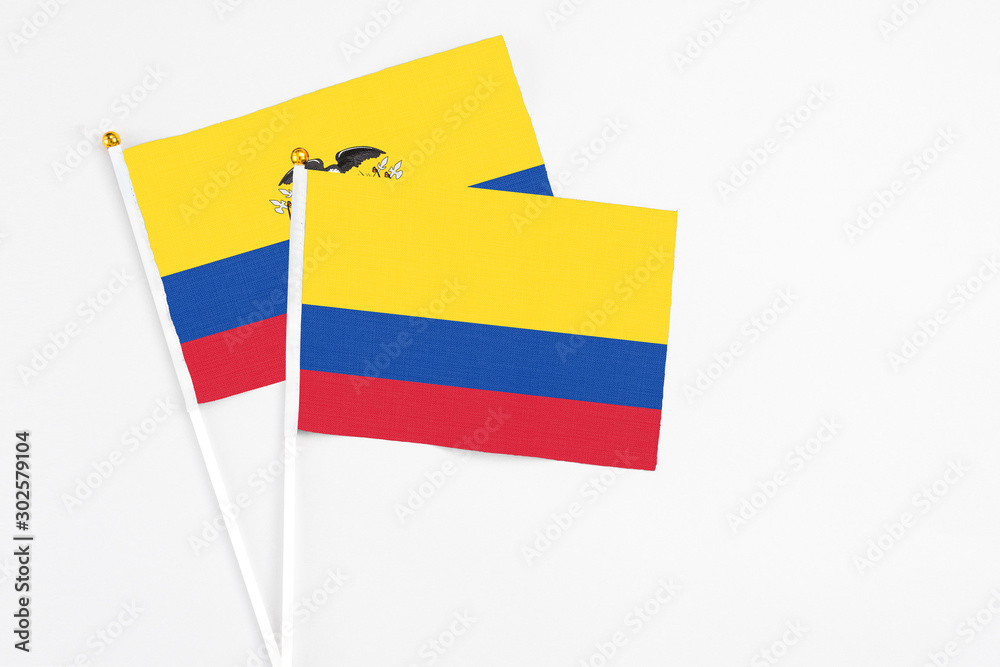 Colombia and Ecuador stick flags on white background. High quality fabric, miniature national flag. Peaceful global concept.White floor for copy space. Colombia and Ecuador stick flags on white background. High quality fabric, miniature national flag. Peaceful global concept.White floor for copy space.