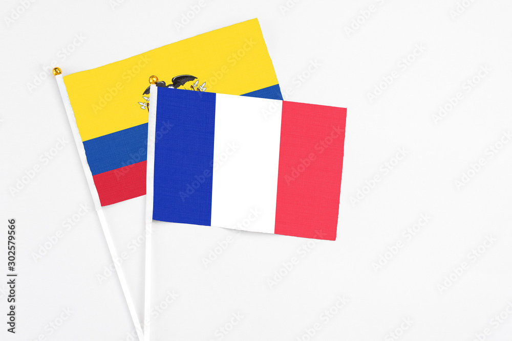 Fototapeta premium France and Ecuador stick flags on white background. High quality fabric, miniature national flag. Peaceful global concept.White floor for copy space.