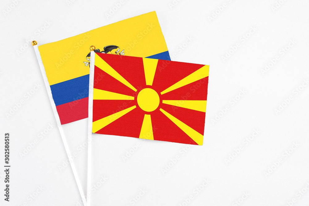 Macedonia and Ecuador stick flags on white background. High quality fabric, miniature national flag. Peaceful global concept.White floor for copy space.