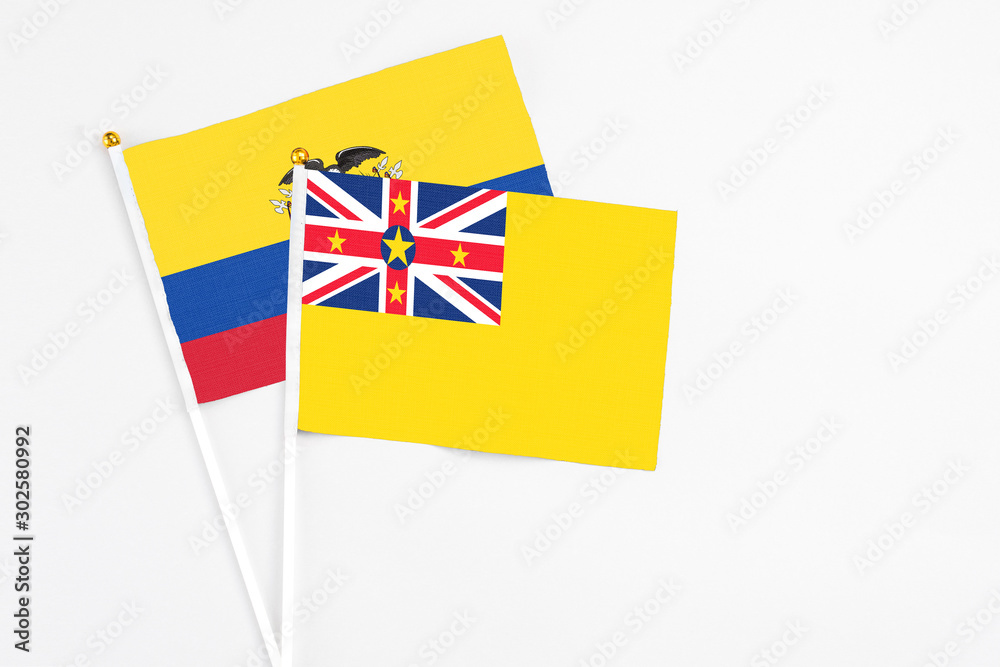 Niue and Ecuador stick flags on white background. High quality fabric, miniature national flag. Peaceful global concept.White floor for copy space. Niue and Ecuador stick flags on white background. High quality fabric, miniature national flag. Peaceful global concept.White floor for copy space.