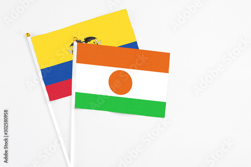 Free Download Niger and Ecuador stick flags on white background. High quality fabric, miniature national flag. Peaceful global concept.White floor for copy space. - GFXLoad