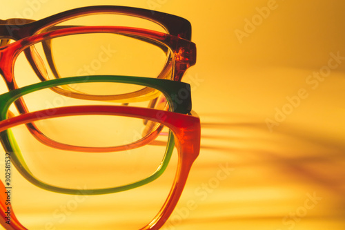 Fototapeta Naklejka Na Ścianę i Meble -  Glasses close up artistic shot. rimmed eyeglasses background with copy space. reading glasses