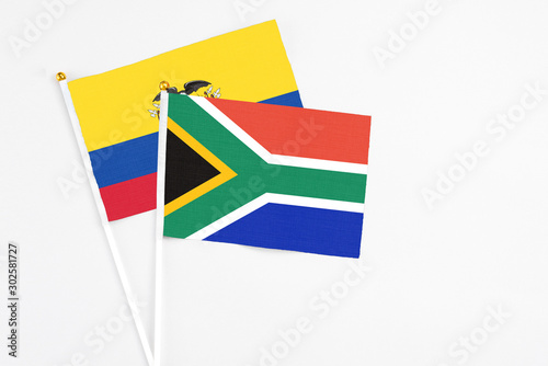 South Africa and Ecuador stick flags on white background. High quality fabric  miniature national flag. Peaceful global concept.White floor for copy space.