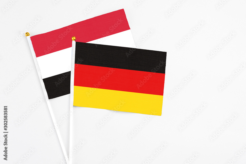 Germany and Egypt stick flags on white background. High quality fabric, miniature national flag. Peaceful global concept.White floor for copy space.