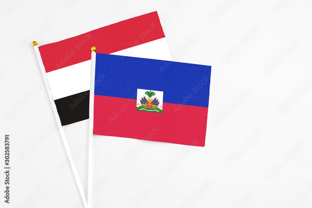 Haiti and Egypt stick flags on white background. High quality fabric, miniature national flag. Peaceful global concept.White floor for copy space.