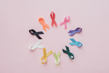 colorful ribbons on pink background, cancer, autism spectrum awareness, World cancer day,  world autism awareness day concept