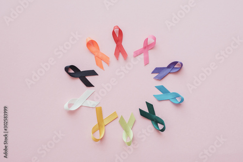 colorful ribbons on pink background, cancer awareness, World cancer day,  world autism awareness day concept photo