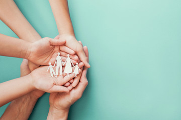hands holding paper family cutout, family home,Autism support, adoption foster care, homeless charity support concept,family mental health,  homeschooling, wellness concept