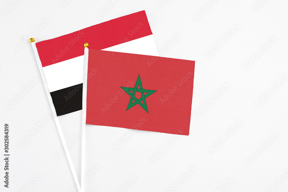 Morocco and Egypt stick flags on white background. High quality fabric, miniature national flag. Peaceful global concept.White floor for copy space. Morocco and Egypt stick flags on white background. High quality fabric, miniature national flag. Peaceful global concept.White floor for copy space.