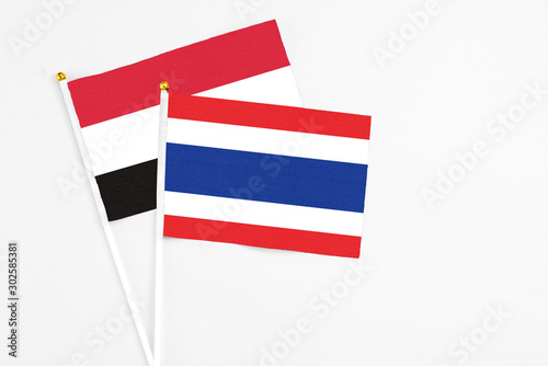 Thailand and Egypt stick flags on white background. High quality fabric  miniature national flag. Peaceful global concept.White floor for copy space.