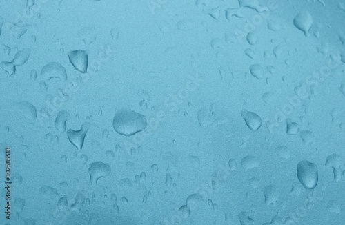 Waterdrop on blue color metal surface.