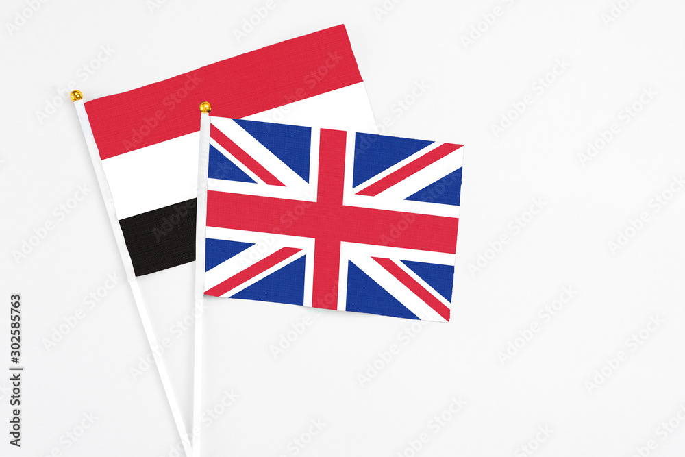 United Kingdom and Egypt stick flags on white background. High quality fabric, miniature national flag. Peaceful global concept.White floor for copy space. United Kingdom and Egypt stick flags on white background. High quality fabric, miniature national flag. Peaceful global concept.White floor for copy space.