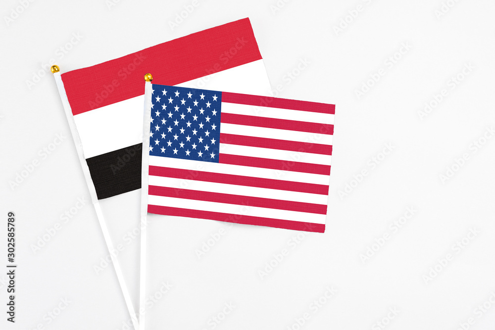 Fototapeta premium United States and Egypt stick flags on white background. High quality fabric, miniature national flag. Peaceful global concept.White floor for copy space.
