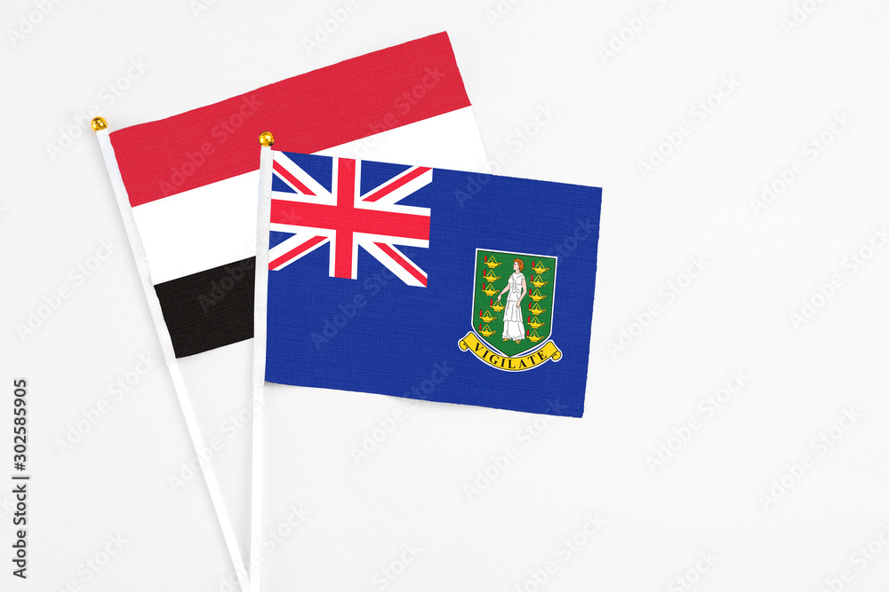 Fototapeta premium British Virgin Islands and Egypt stick flags on white background. High quality fabric, miniature national flag. Peaceful global concept.White floor for copy space.