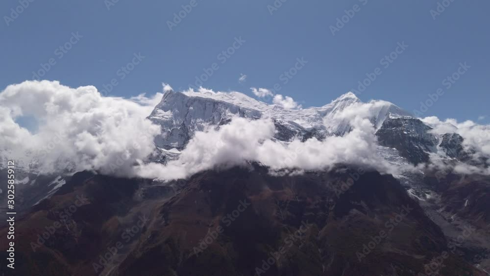 annapurna peak covered with snow in a sunny day with cloud moving, famous trekking annapurna circuit nepal annapurna peak covered with snow in a sunny day with cloud moving, famous trekking annapurna circuit nepal