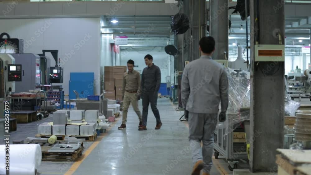Chinese engineers walking and talking in factory,HD