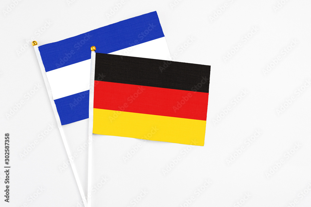 Obraz premium Germany and El Salvador stick flags on white background. High quality fabric, miniature national flag. Peaceful global concept.White floor for copy space.