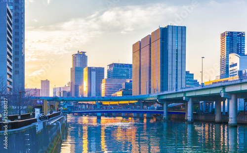 Dojima River and buildings at sunset in Osaka, Japan photo