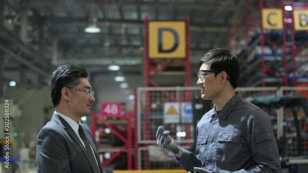 Confident Chinese Manager and engineer talking in factory,HD