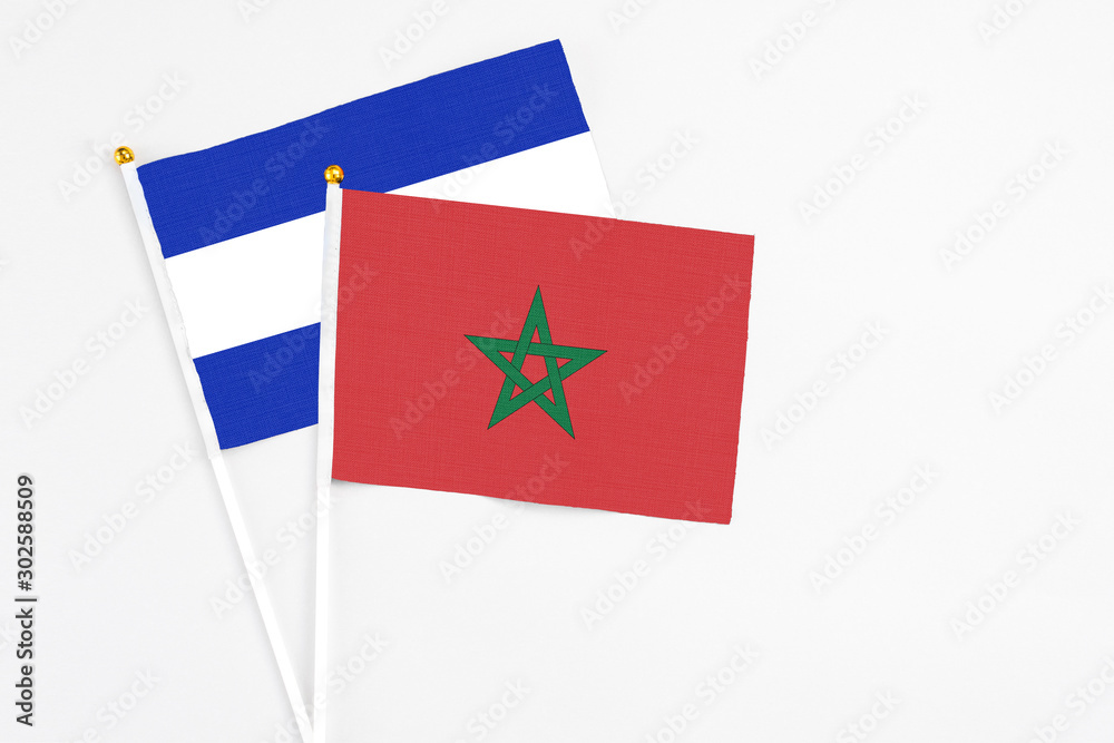 Morocco and El Salvador stick flags on white background. High quality fabric, miniature national flag. Peaceful global concept.White floor for copy space. Morocco and El Salvador stick flags on white background. High quality fabric, miniature national flag. Peaceful global concept.White floor for copy space.