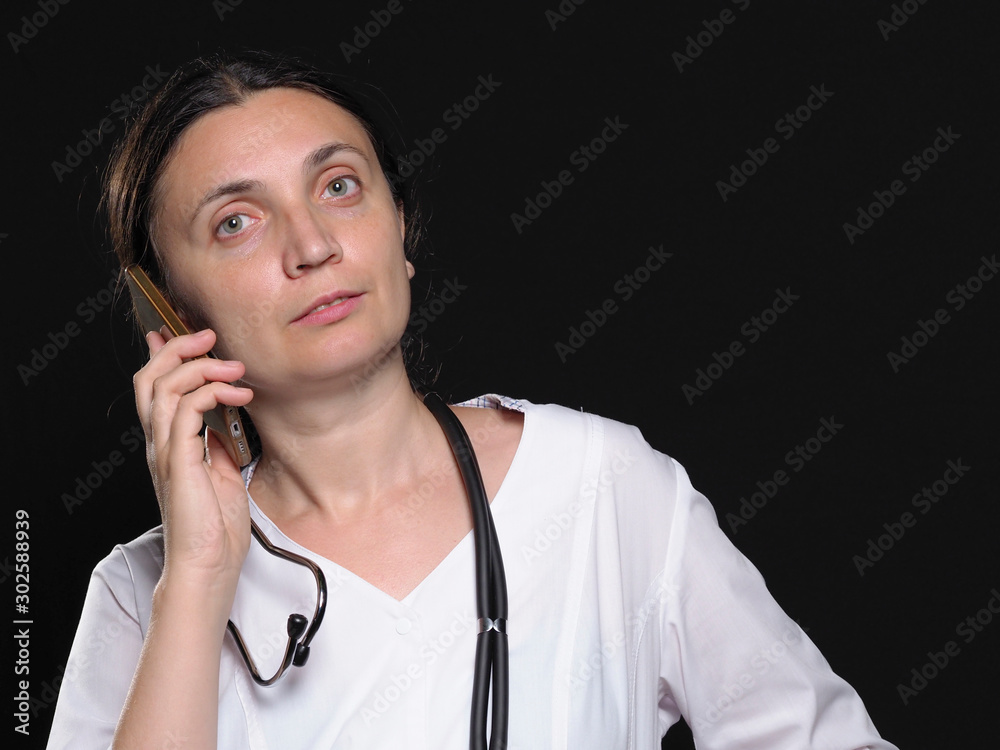 female doctor shows different emotions posing with phone Female doctor in white coat shows different emotions posing on black background. Doctor template. female doctor shows different emotions posing with phone Female doctor in white coat shows different emotions posing on black background. Doctor template.