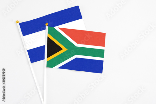 South Africa and El Salvador stick flags on white background. High quality fabric  miniature national flag. Peaceful global concept.White floor for copy space.