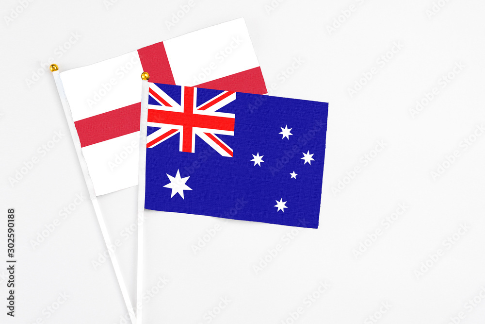 Fototapeta premium Australia and England stick flags on white background. High quality fabric, miniature national flag. Peaceful global concept.White floor for copy space.