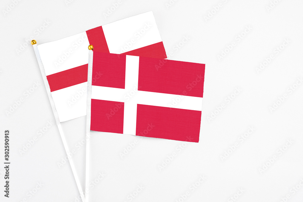 Denmark and England stick flags on white background. High quality fabric, miniature national flag. Peaceful global concept.White floor for copy space.