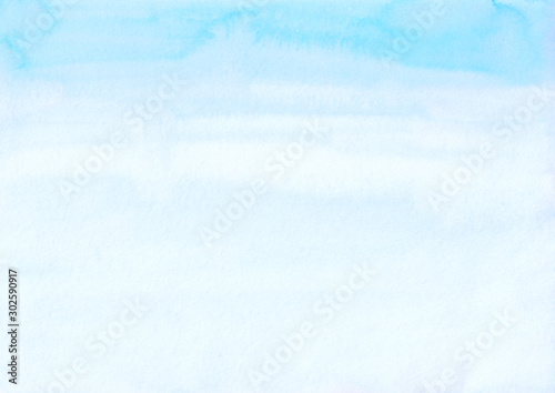 Watercolor light blue and white background texture. Pastel blue and white ombre backdrop. Stains on paper.