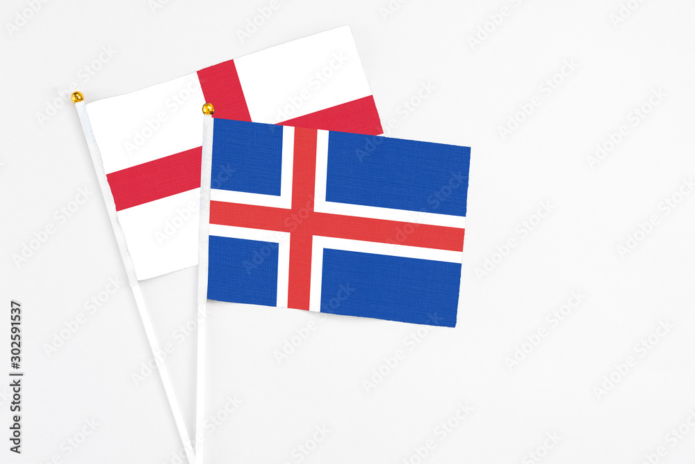 Iceland and England stick flags on white background. High quality fabric, miniature national flag. Peaceful global concept.White floor for copy space.