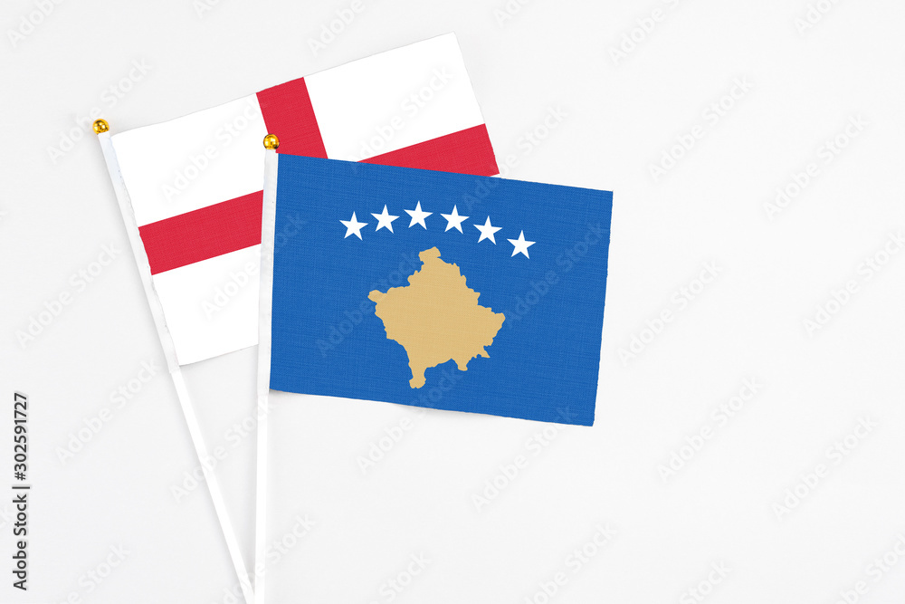 Naklejka premium Kosovo and England stick flags on white background. High quality fabric, miniature national flag. Peaceful global concept.White floor for copy space.