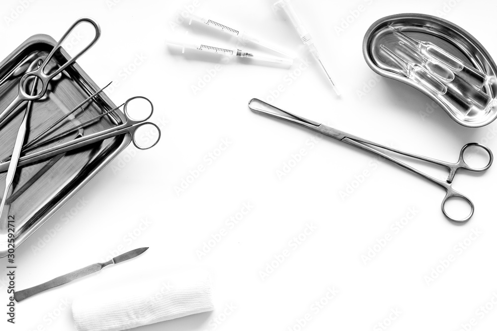 Fototapeta premium Plastic surgery instruments and tools with bandage on white background top view frame copy space
