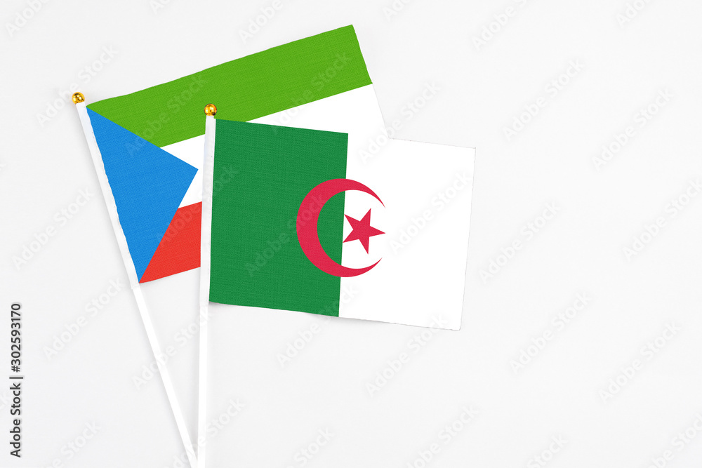 Algeria and Equatorial Guinea stick flags on white background. High quality fabric, miniature national flag. Peaceful global concept.White floor for copy space. Algeria and Equatorial Guinea stick flags on white background. High quality fabric, miniature national flag. Peaceful global concept.White floor for copy space.