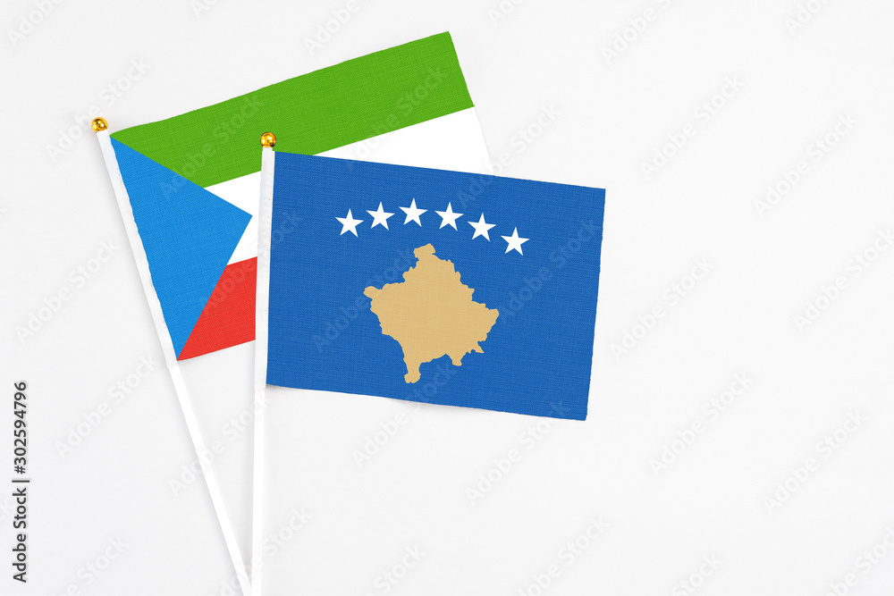 Kosovo and Equatorial Guinea stick flags on white background. High quality fabric, miniature national flag. Peaceful global concept.White floor for copy space. Kosovo and Equatorial Guinea stick flags on white background. High quality fabric, miniature national flag. Peaceful global concept.White floor for copy space.