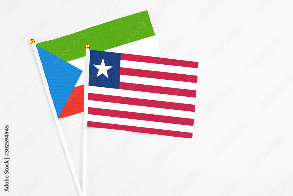 Liberia and Equatorial Guinea stick flags on white background. High quality fabric, miniature national flag. Peaceful global concept.White floor for copy space. Liberia and Equatorial Guinea stick flags on white background. High quality fabric, miniature national flag. Peaceful global concept.White floor for copy space.