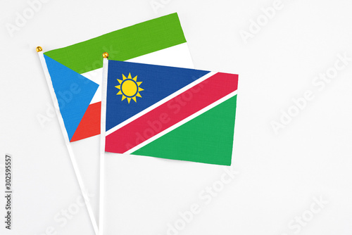 Free Download Namibia and Equatorial Guinea stick flags on white background. High quality fabric, miniature national flag. Peaceful global concept.White floor for copy space. - GFXLoad