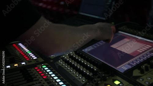 remote recordists closeup. Hand adjusts sound effects. Electric machine on table for working of sound designer or club dj at party in nightclub. Occupation for modern lifestyle, objects for listen at  photo