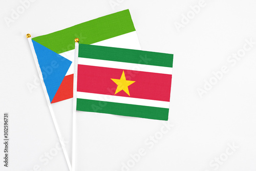 Suriname and Equatorial Guinea stick flags on white background. High quality fabric, miniature national flag. Peaceful global concept.White floor for copy space. Free Download Suriname and Equatorial Guinea stick flags on white background. High quality fabric, miniature national flag. Peaceful global concept.White floor for copy space. - GFXLoad