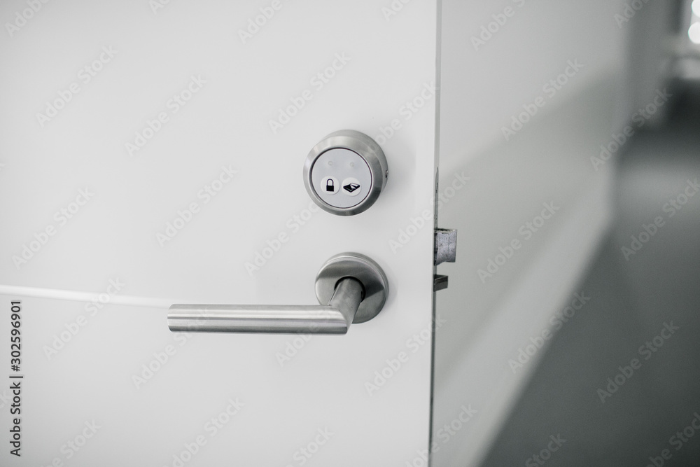 Electronic lock on door with white key card, Hotel electronic lock on white door Electronic lock on door with white key card, Hotel electronic lock on white door