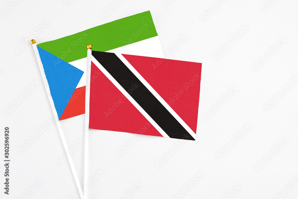 Trinidad And Tobago and Equatorial Guinea stick flags on white background. High quality fabric, miniature national flag. Peaceful global concept.White floor for copy space. Trinidad And Tobago and Equatorial Guinea stick flags on white background. High quality fabric, miniature national flag. Peaceful global concept.White floor for copy space.
