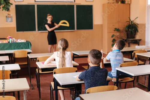 Back view of children sitting in the class room and study. Elementary school