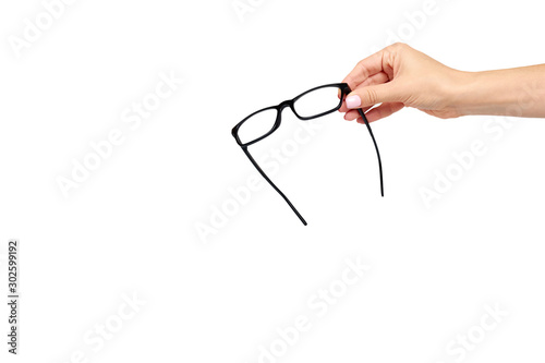 Hand with black eyeglasses, eye optic correction tool.