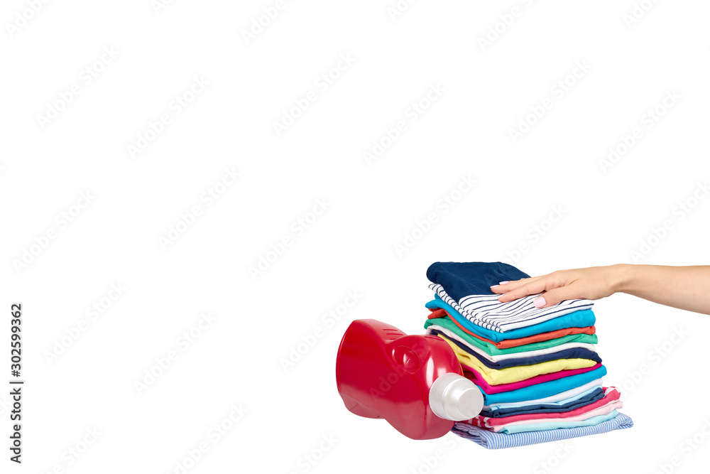 Hand with stack of clothes and detergent bottle, fresh laundry textile. Hand with stack of clothes and detergent bottle, fresh laundry textile.