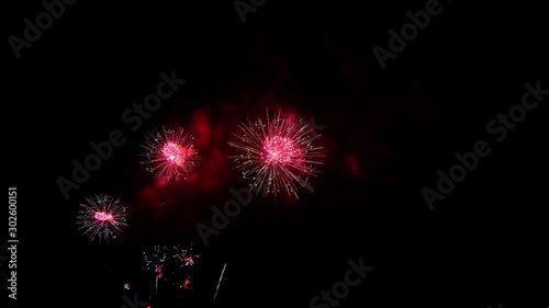 Beautiful colorful holiday fireworks on the black sky background