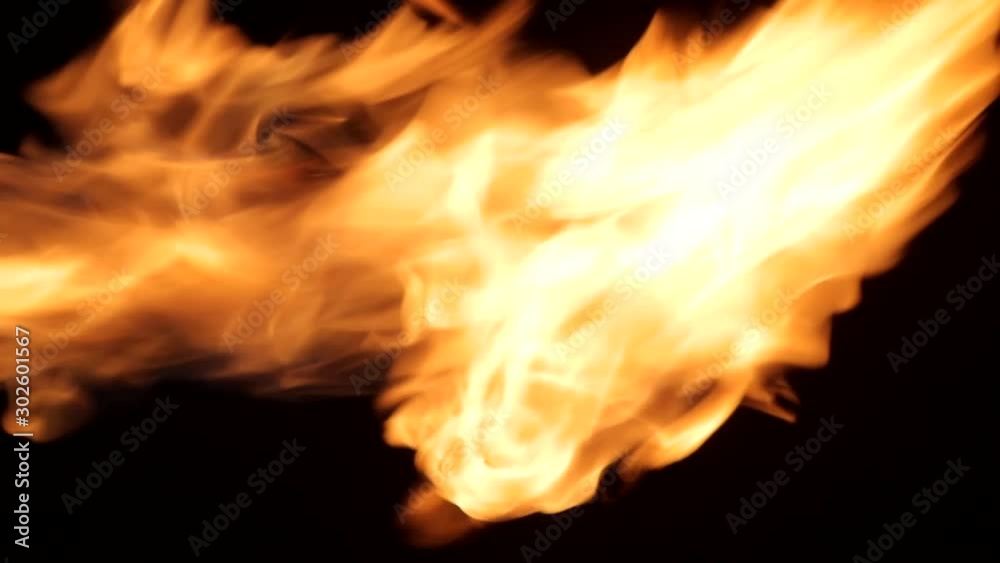 Strong flame throw out from side to the top so long angrily on black background. For overlay effect Strong flame throw out from side to the top so long angrily on black background. For overlay effect