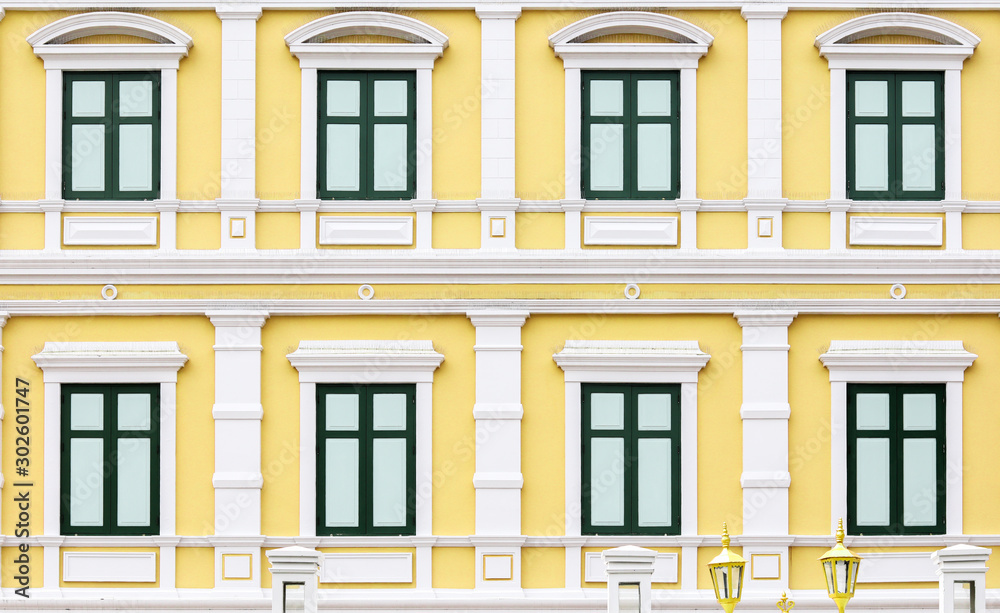 Green windows on a yellow building