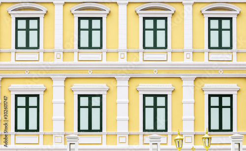 Green windows on a yellow building