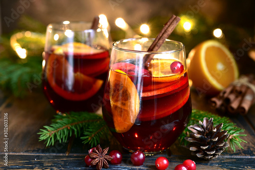 Red spicy christmas mulled wine with cranberries, apple and orange. photo