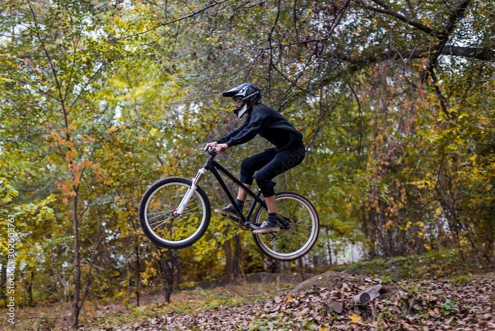 Extreme cycling concept: mountain bike rider makes a jump. Extreme cycling concept: mountain bike rider makes a jump.